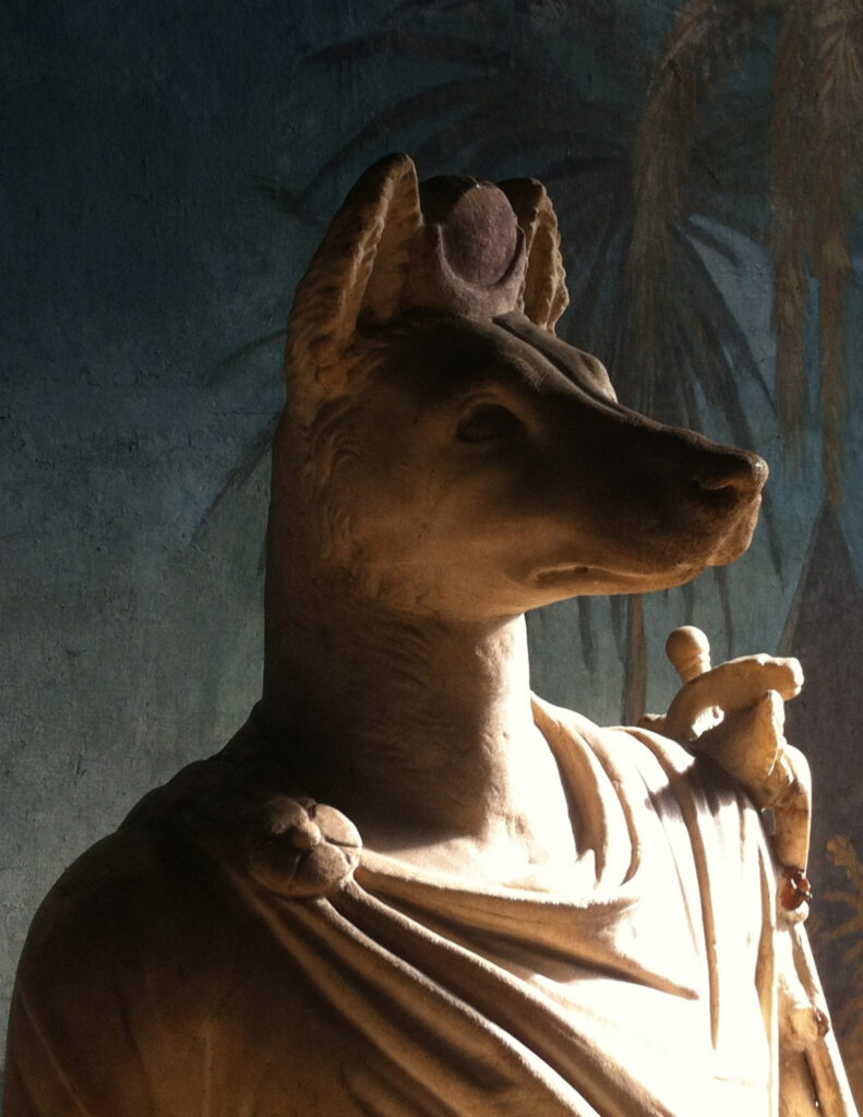 A stone statue of Anubis.