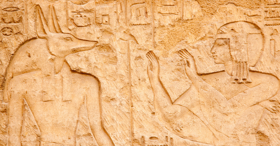 A carving of Anubis and a human.