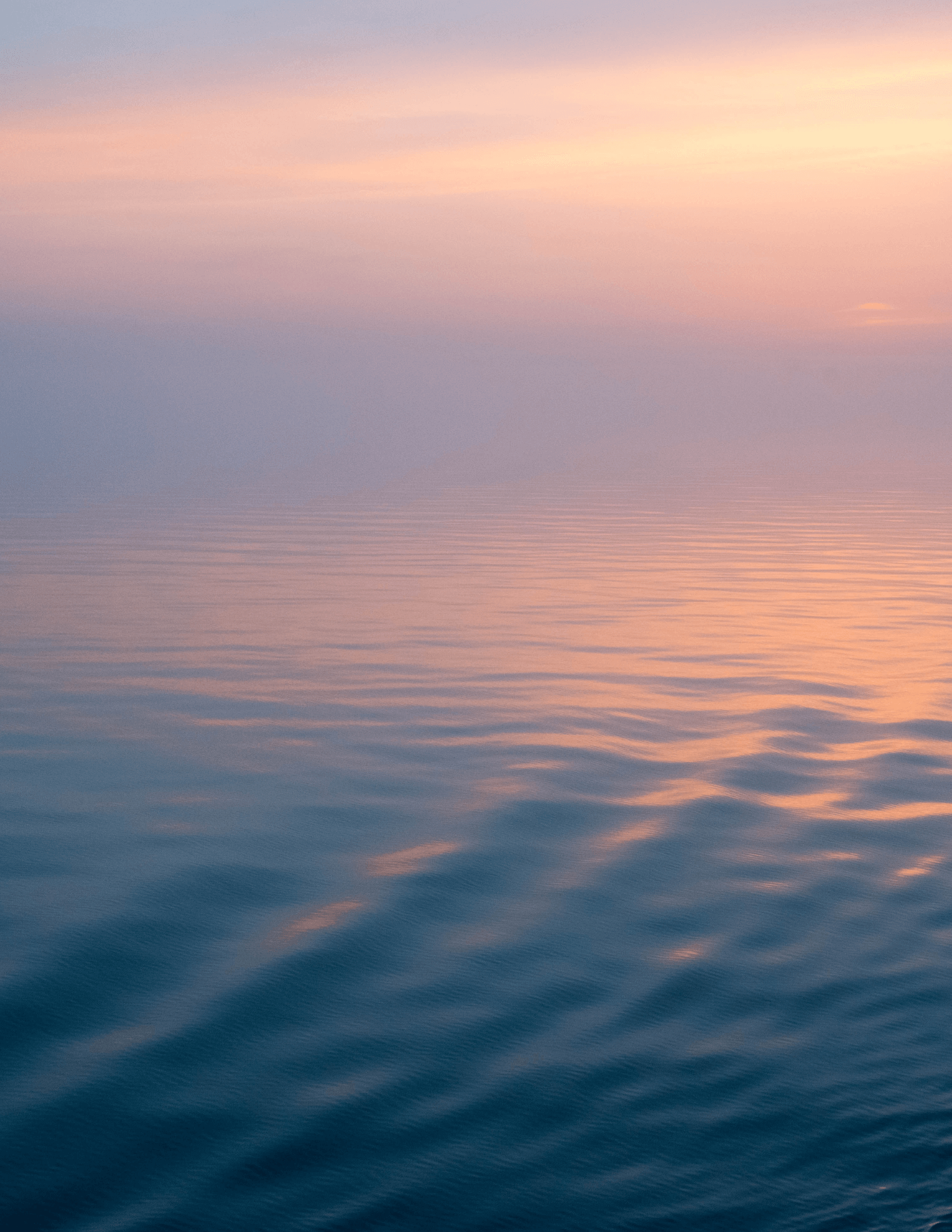 Calm sea water at sunset.