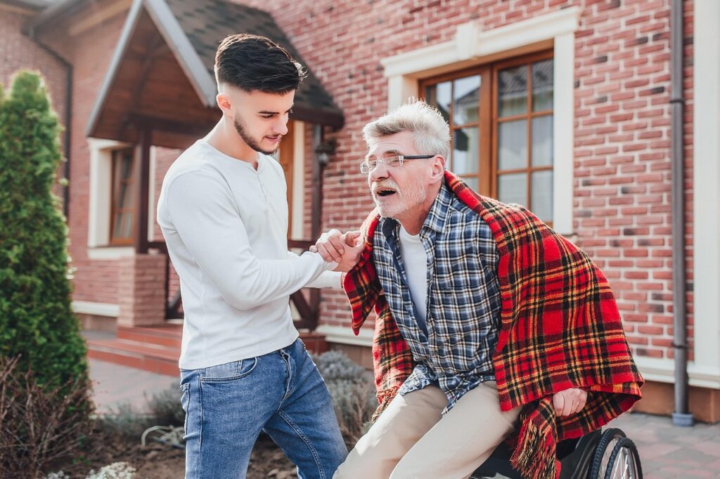 A young guy assinting an elderly person