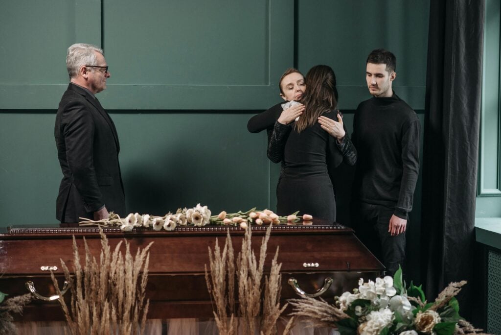 people making final farewell to loved one people making final farewell to loved one