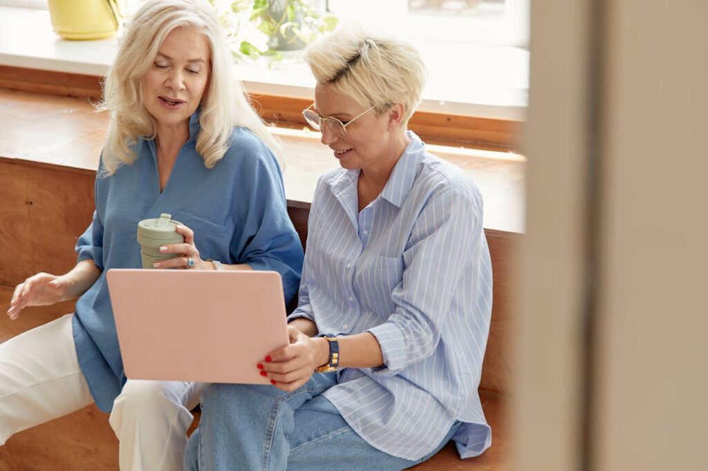 two women talking holding a tablet