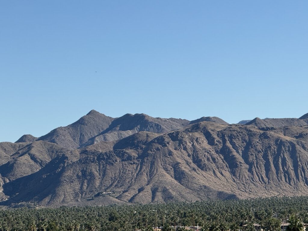 Dry mountain range under a clear blue sky.