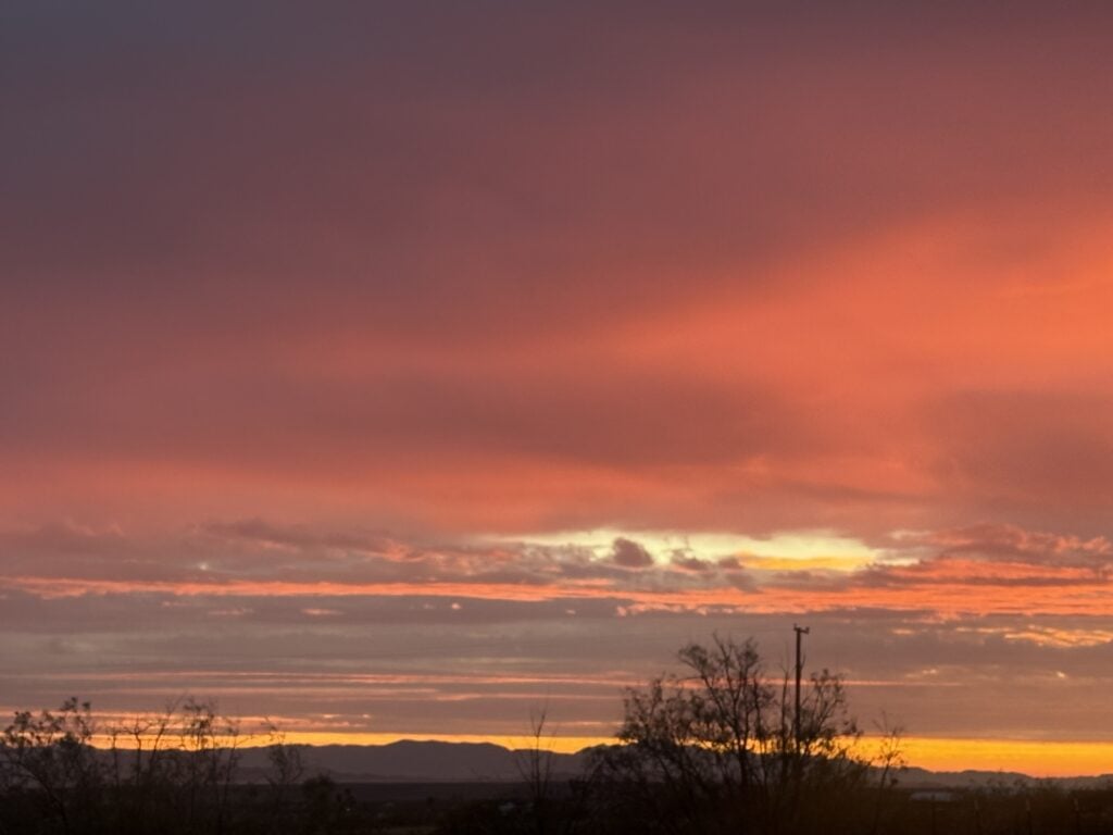 Red and orange sunrise over the California mountains with layered clouds