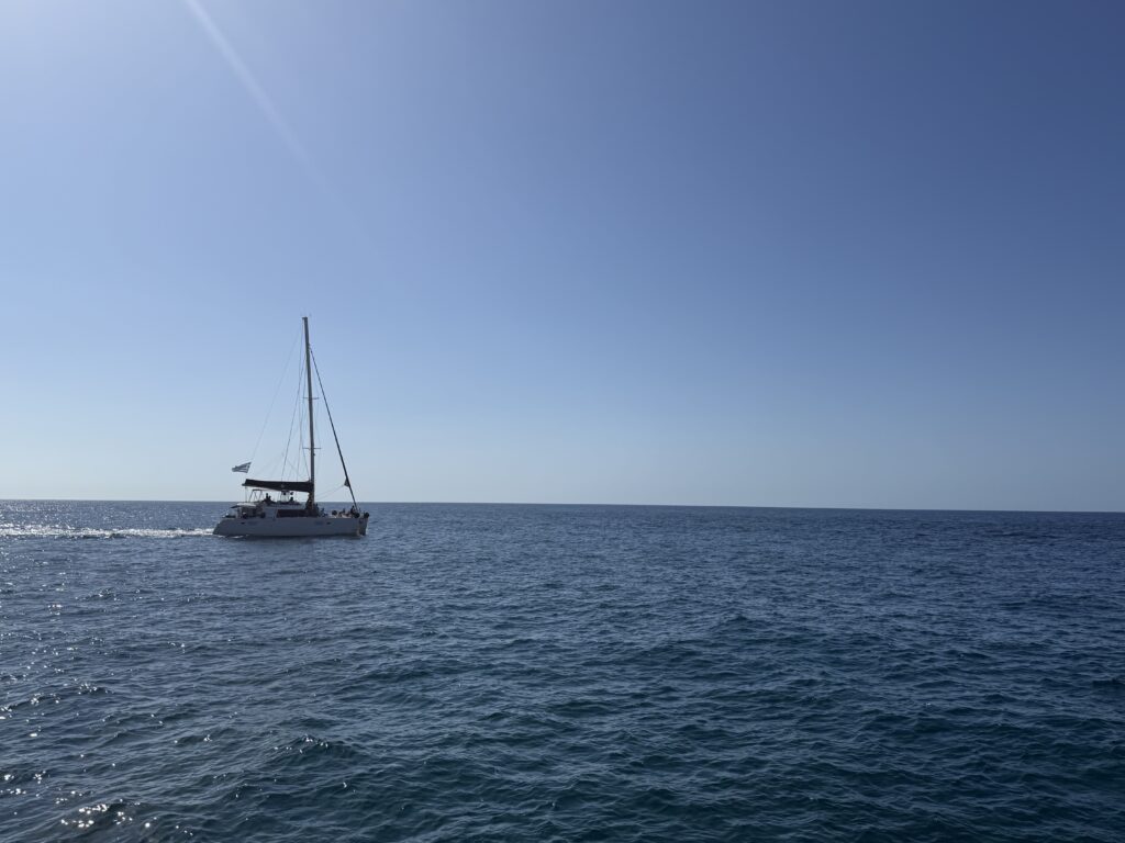 Calm sailboat on open ocean