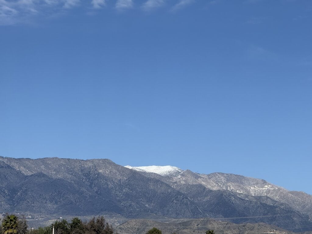 Mountain landscape beneath a clear blue sky.