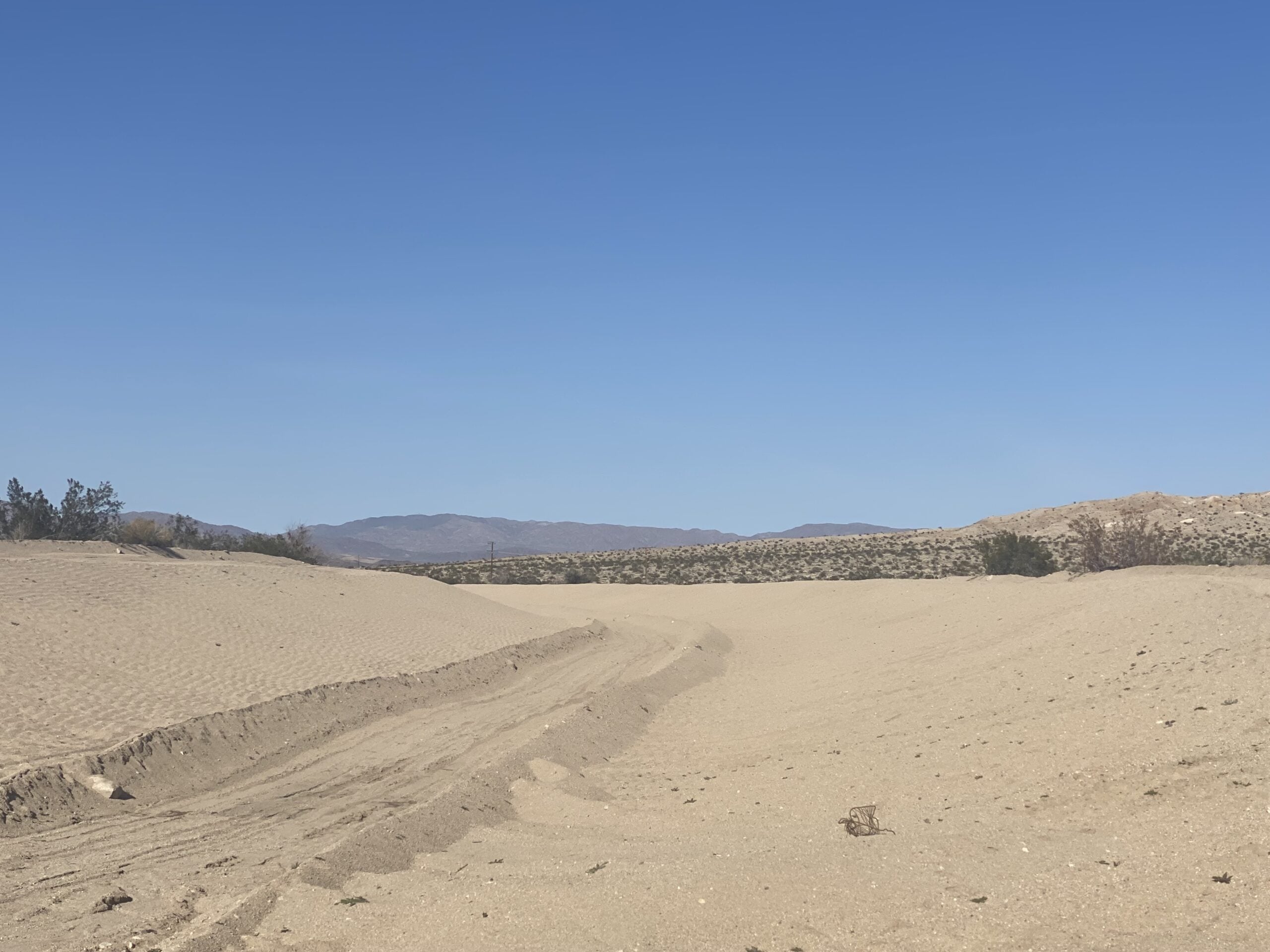A quiet desert landscape with soft sand