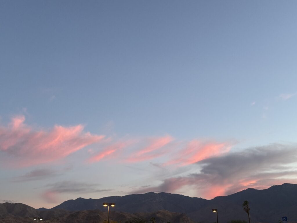 Pink clouds across evening sky.