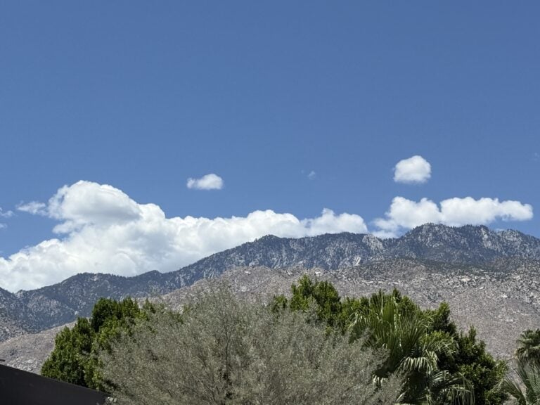 Blue sky over mountain landscape.