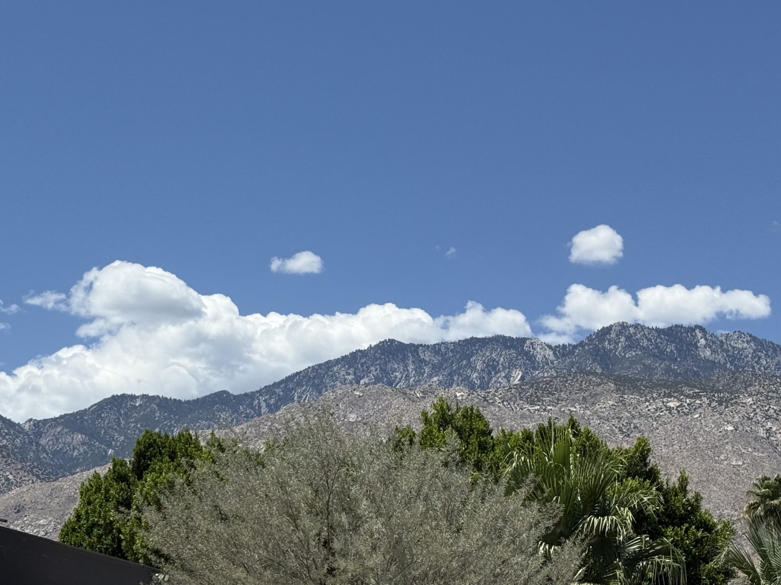 Blue sky over mountain landscape.