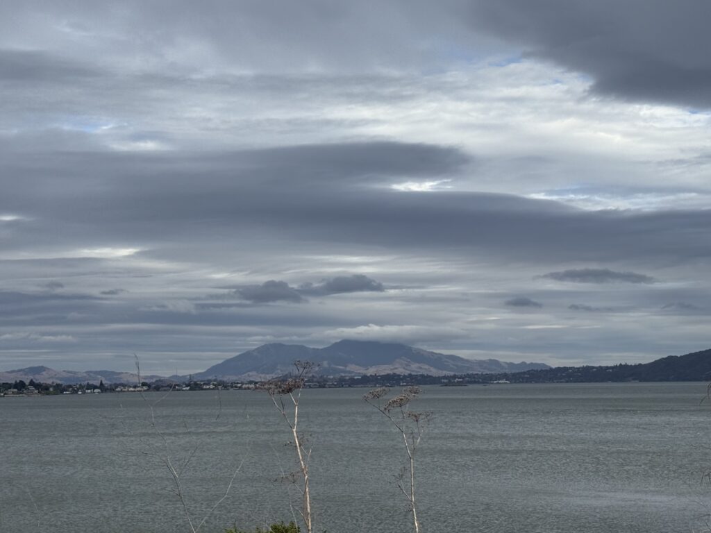 Cloudy lake view with distant mountains